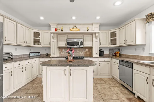 a bedroom with a bed couch and window