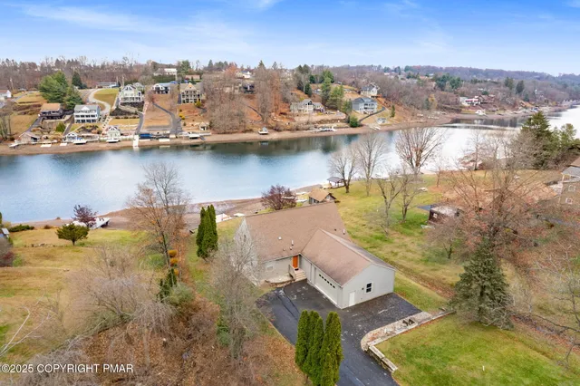 an aerial view of a house with a lake view