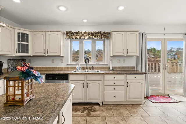 a en suite bathroom with a double vanity sink a mirror and a shower
