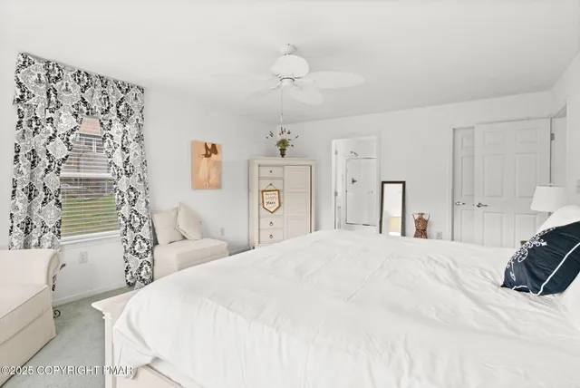 a bathroom with a granite countertop toilet a sink and a mirror