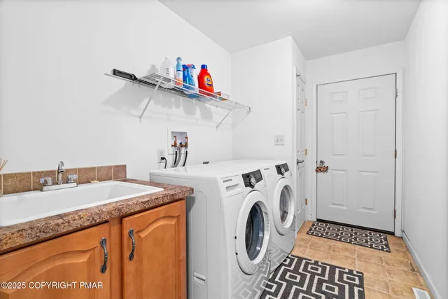 a living room with furniture pool table and windows