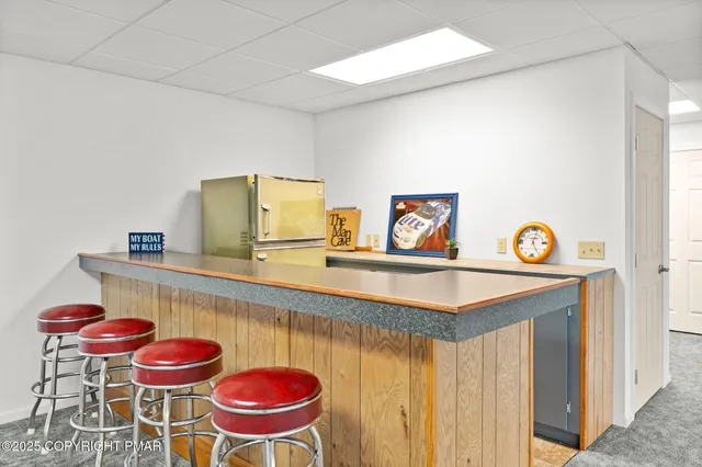 a view of a house with a big yard and large trees