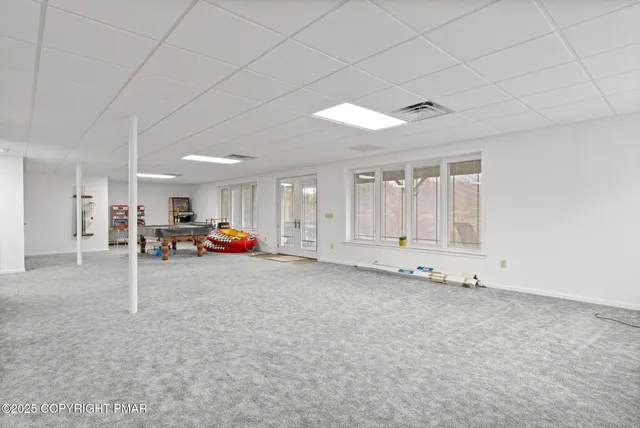 a view of a porch with chairs and backyard