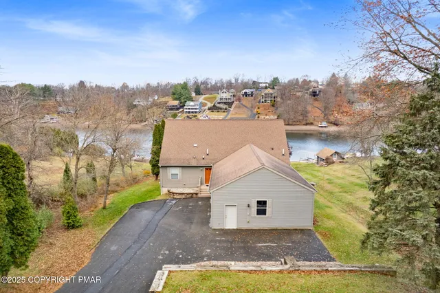 a view of a house with a patio and a yard