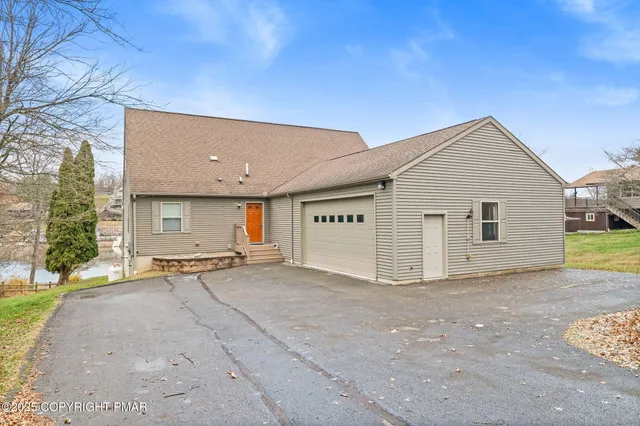 a view of a house with a yard and garage