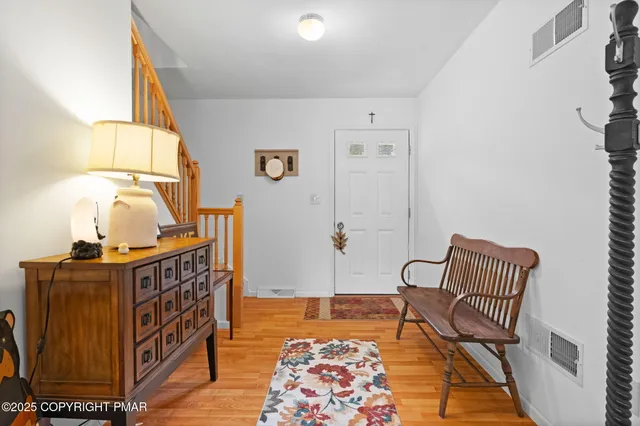 a view of a dining room with furniture and a chandelier