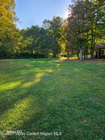 a view of outdoor space with deck and yard