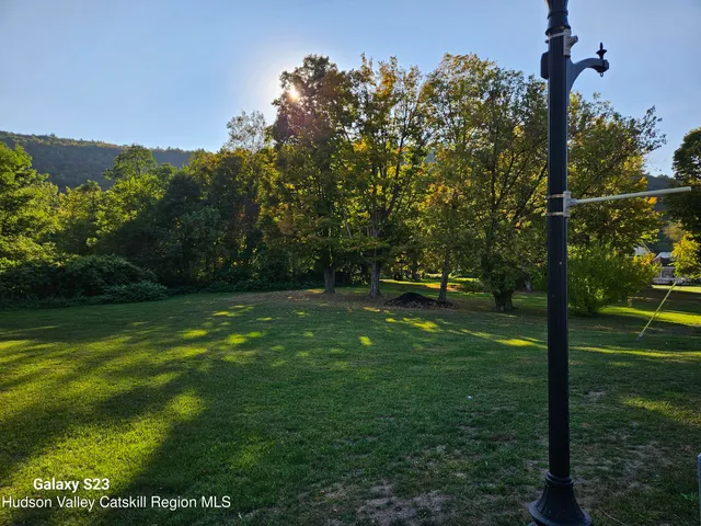 a picture of a bathroom with shower and mirror