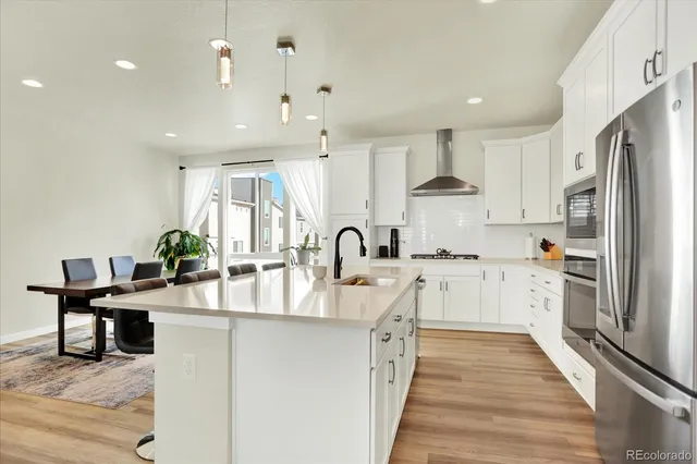 a kitchen with stainless steel appliances a sink stove and refrigerator