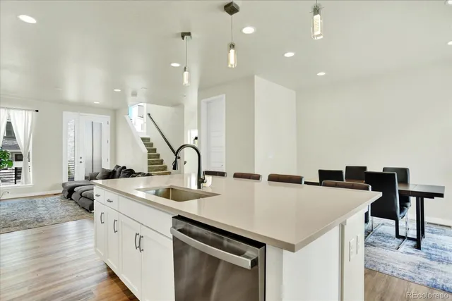 a kitchen with a sink a stove and chairs