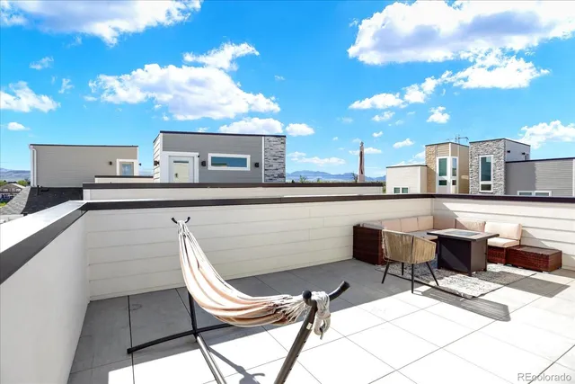 a balcony with chairs and a table