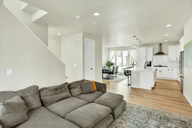 a living room with furniture and kitchen view