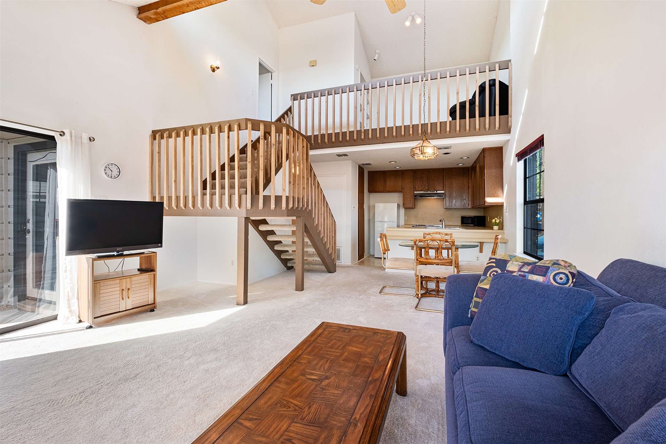 1748 Ohlen Road, Unit 16 Austin, TX 78757 - Photo 8 of 38 Living area with light carpet, a high ceiling, and ceiling fan