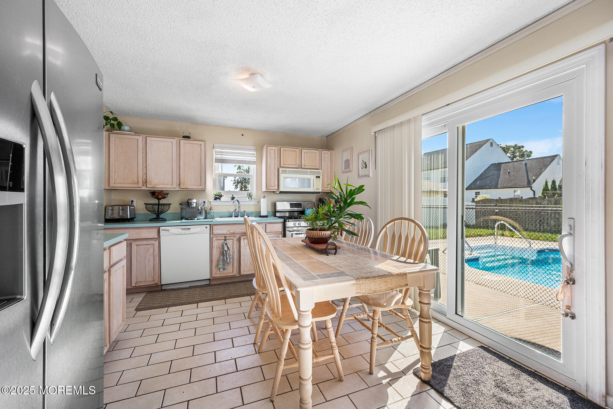 33 Bryce Canyon Road Howell, NJ 07731 - Photo 14 of 44 a kitchen with granite countertop a refrigerator a stove a sink and cabinets