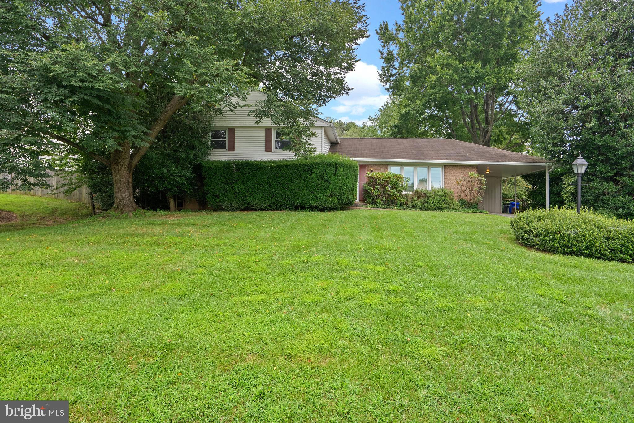 4004 Briars Road Olney, MD 20832 - Photo 1 of 46 a front view of a house with a yard and trees