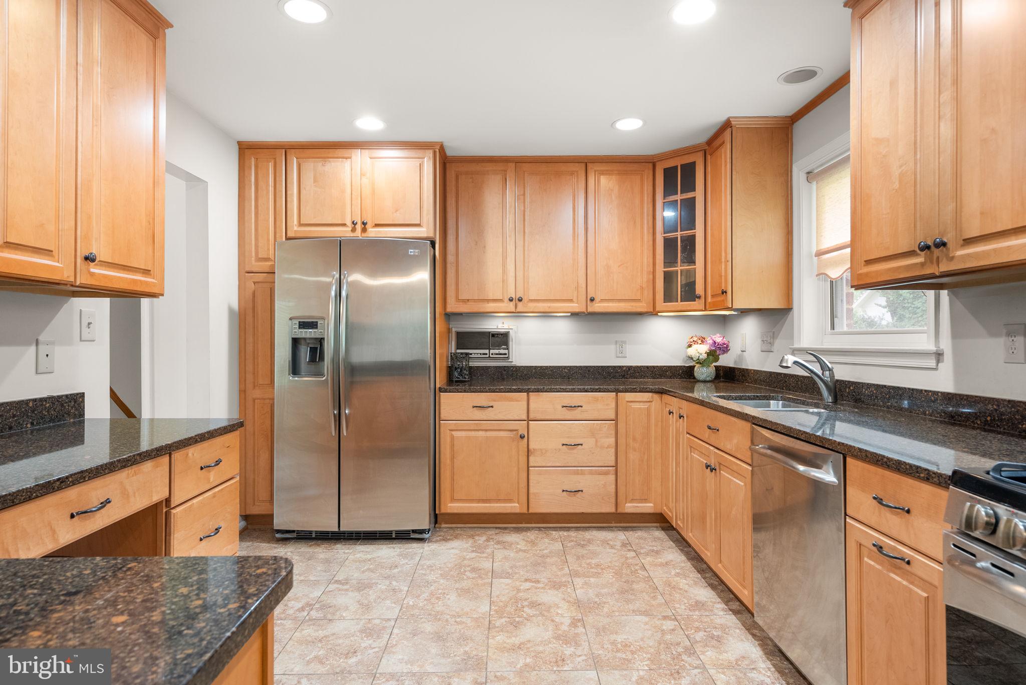 4004 Briars Road Olney, MD 20832 - Photo 12 of 46 a kitchen with stainless steel appliances granite countertop a refrigerator sink and cabinets