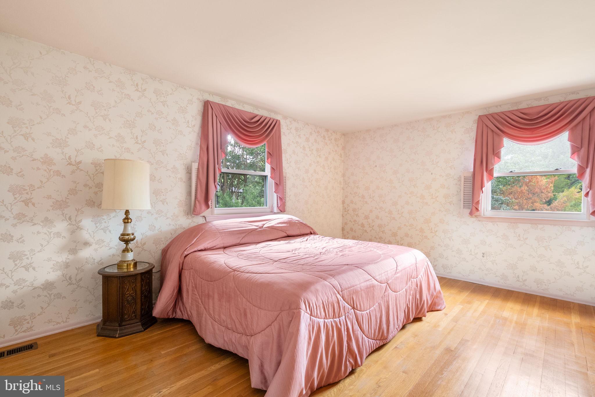 4004 Briars Road Olney, MD 20832 - Photo 23 of 46 a bedroom with a bed and a painting on the wall