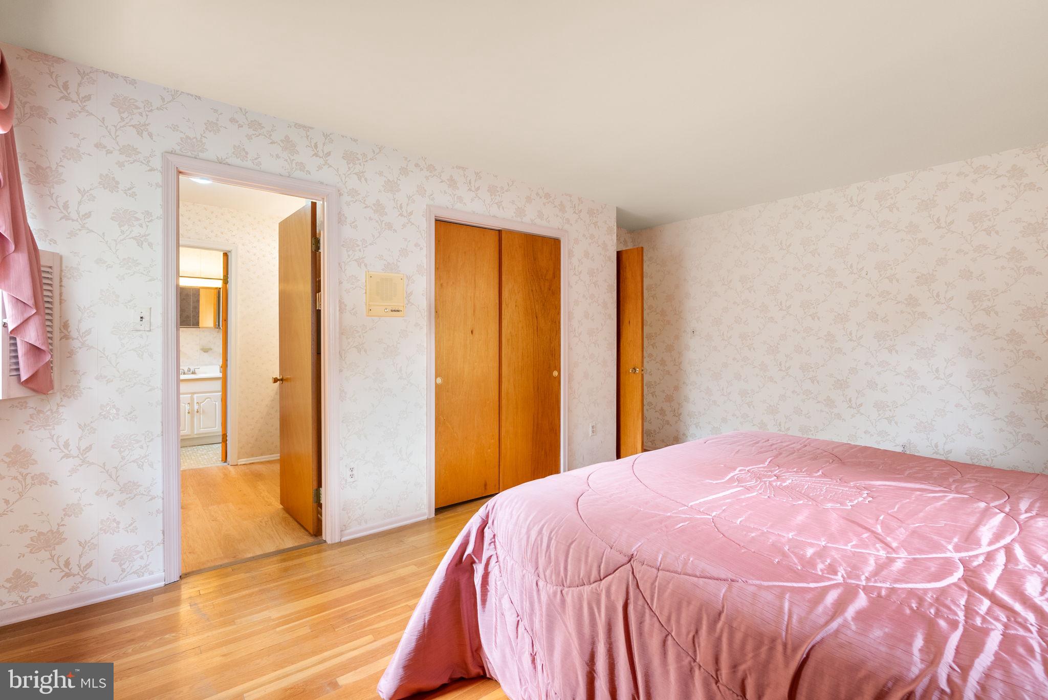 4004 Briars Road Olney, MD 20832 - Photo 25 of 46 a bedroom with a bed and wooden floor