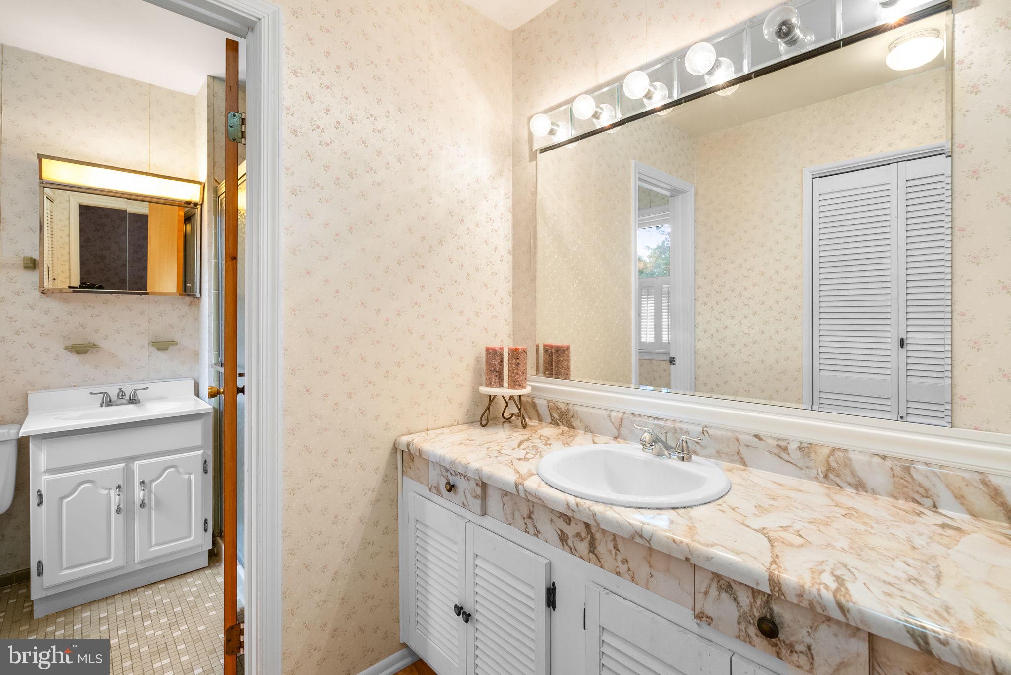 4004 Briars Road Olney, MD 20832 - Photo 26 of 46 a bathroom with a granite countertop sink and a mirror