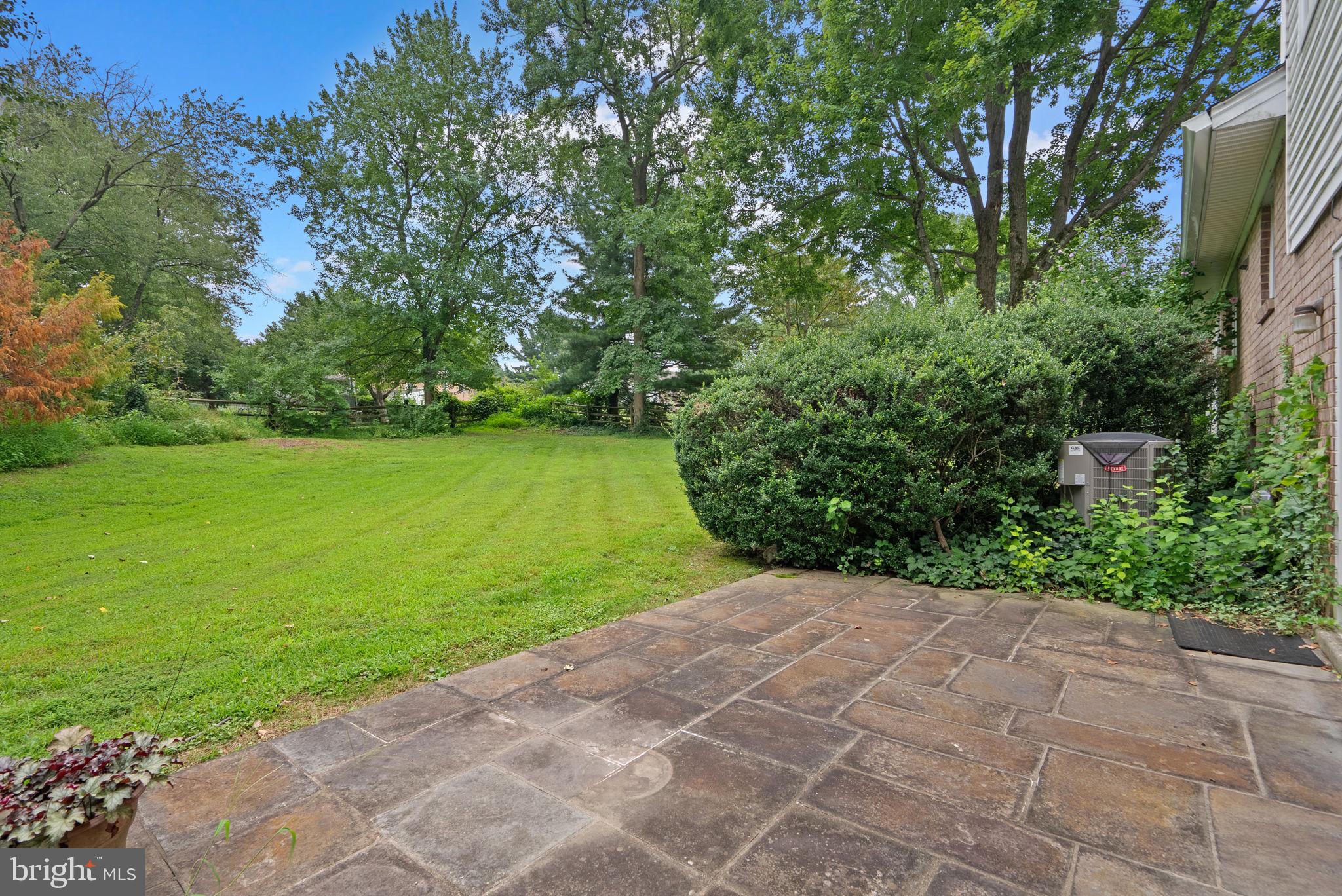 4004 Briars Road Olney, MD 20832 - Photo 40 of 46 a view of a backyard with potted plants and large trees