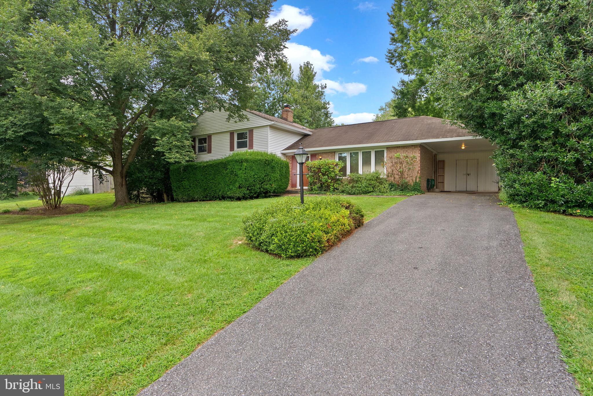 4004 Briars Road Olney, MD 20832 - Photo 4 of 46 a view of a big house with a big yard and large trees