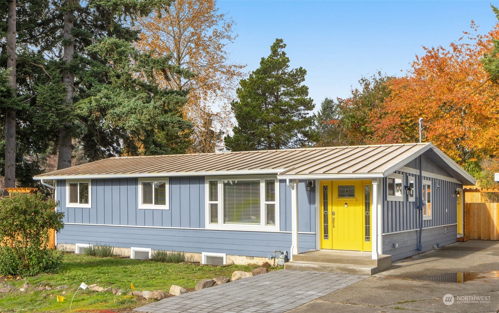 a front view of a house with a garden and yard