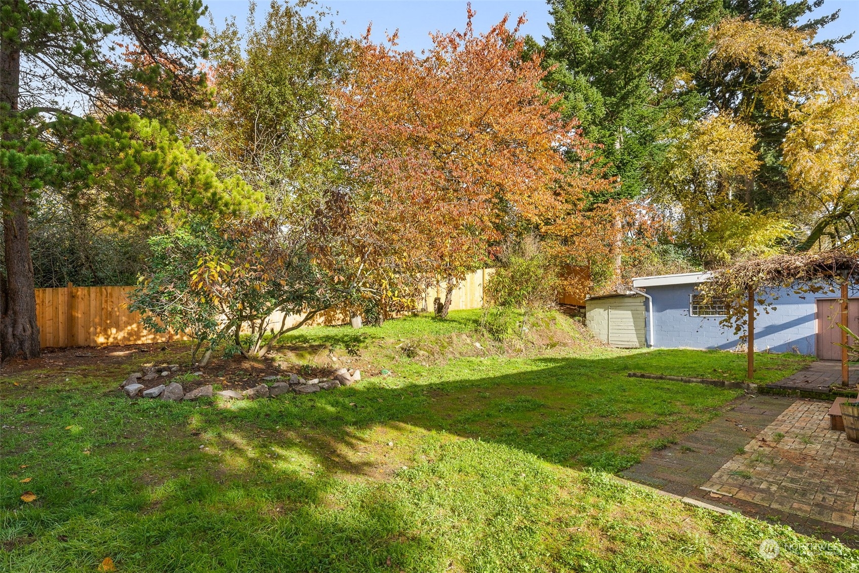 2914 Northeast 6th Street Renton, WA 98056 - Photo 33 of 35 a backyard of a house with plants and large trees