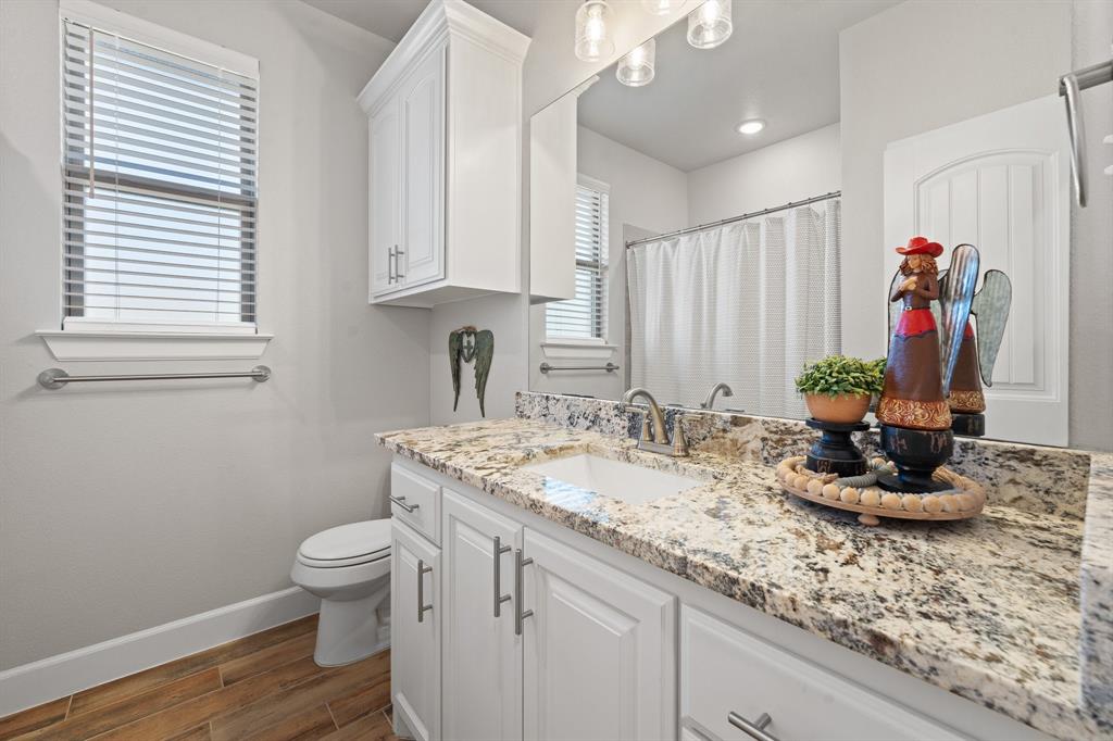 1741 River Bend Road Burleson, TX 76028 - Photo 24 of 33 Bathroom with a shower with curtain, vanity, and wood tiled floors