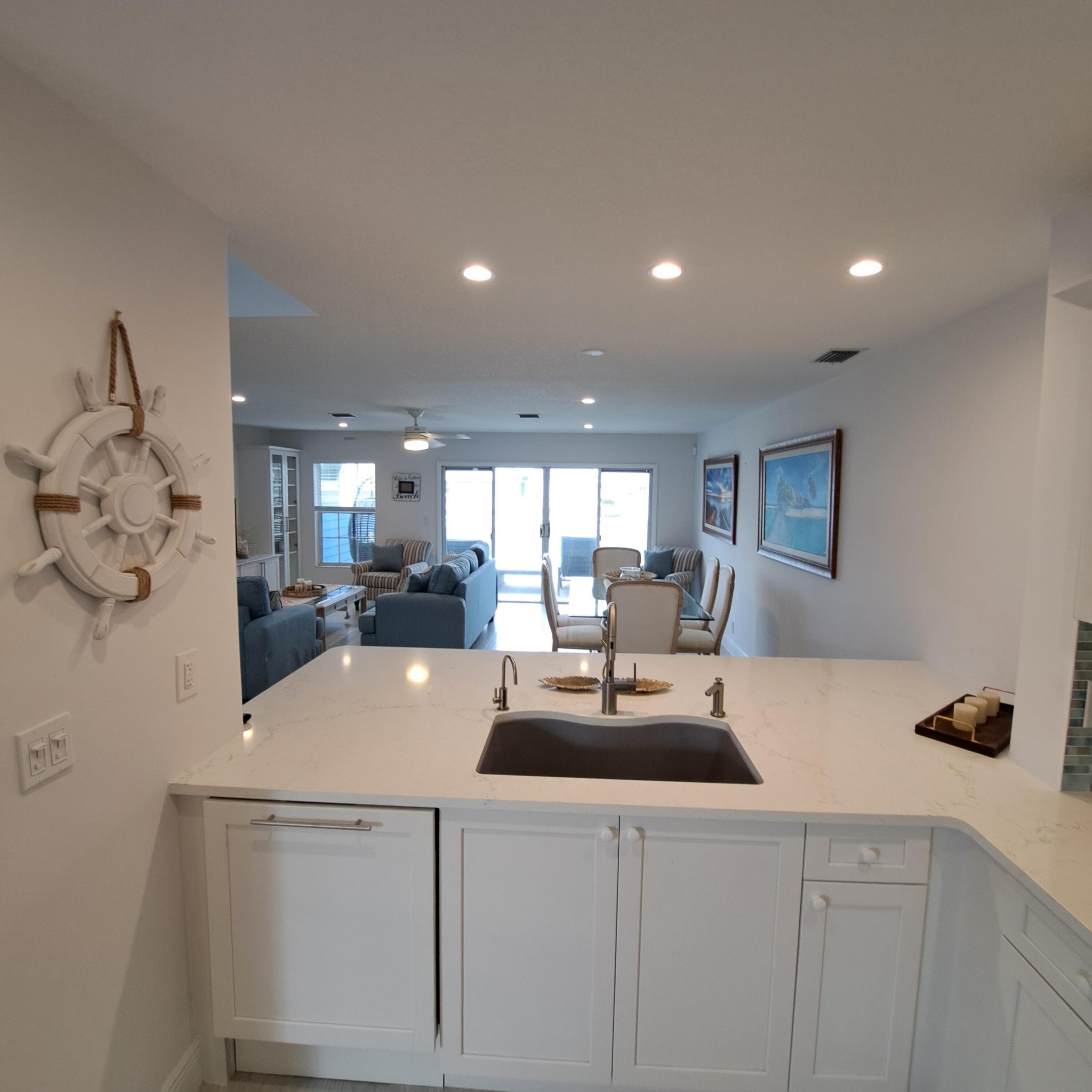 904 Ocean Dunes Circle Jupiter, FL 33477 - Photo 11 of 49 a large kitchen with kitchen island a sink table and chairs