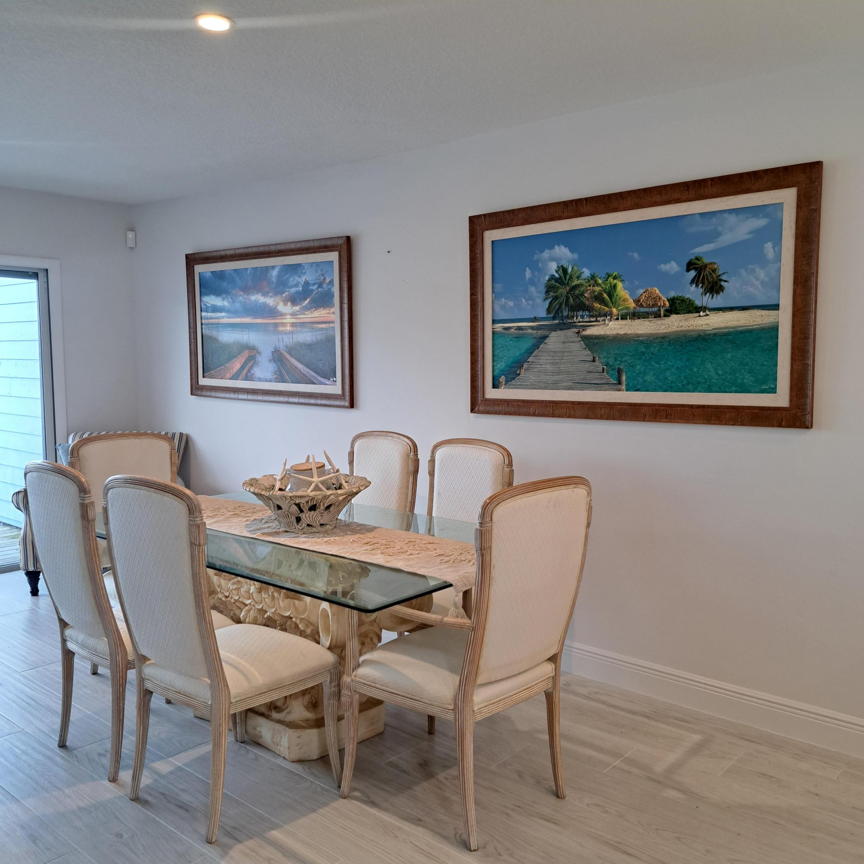 904 Ocean Dunes Circle Jupiter, FL 33477 - Photo 14 of 49 a view of a dining room with furniture a rug and wooden floor