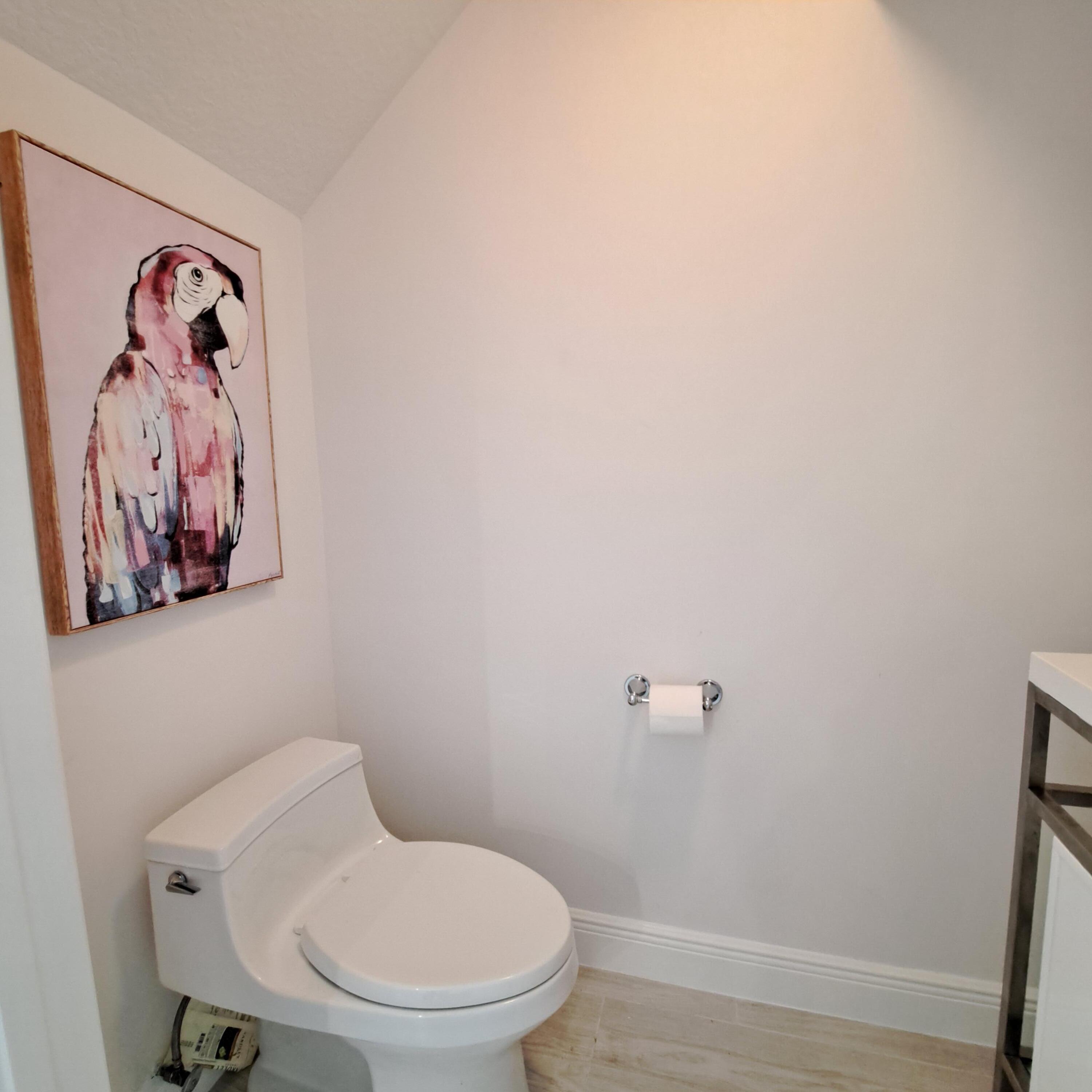 904 Ocean Dunes Circle Jupiter, FL 33477 - Photo 15 of 49 a white toilet sitting next to a bathroom sink