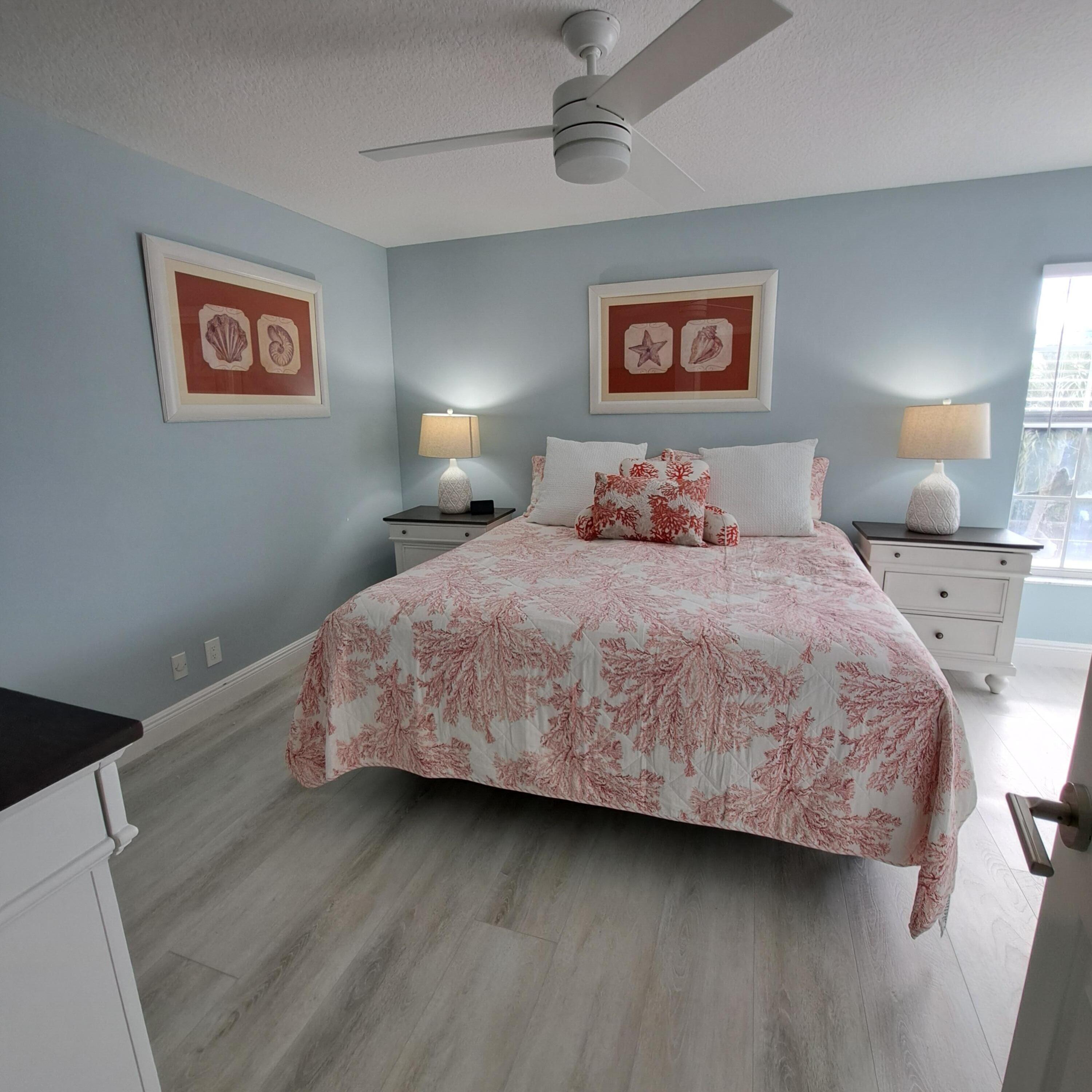 904 Ocean Dunes Circle Jupiter, FL 33477 - Photo 23 of 49 a bedroom with a bed and painting on the wall