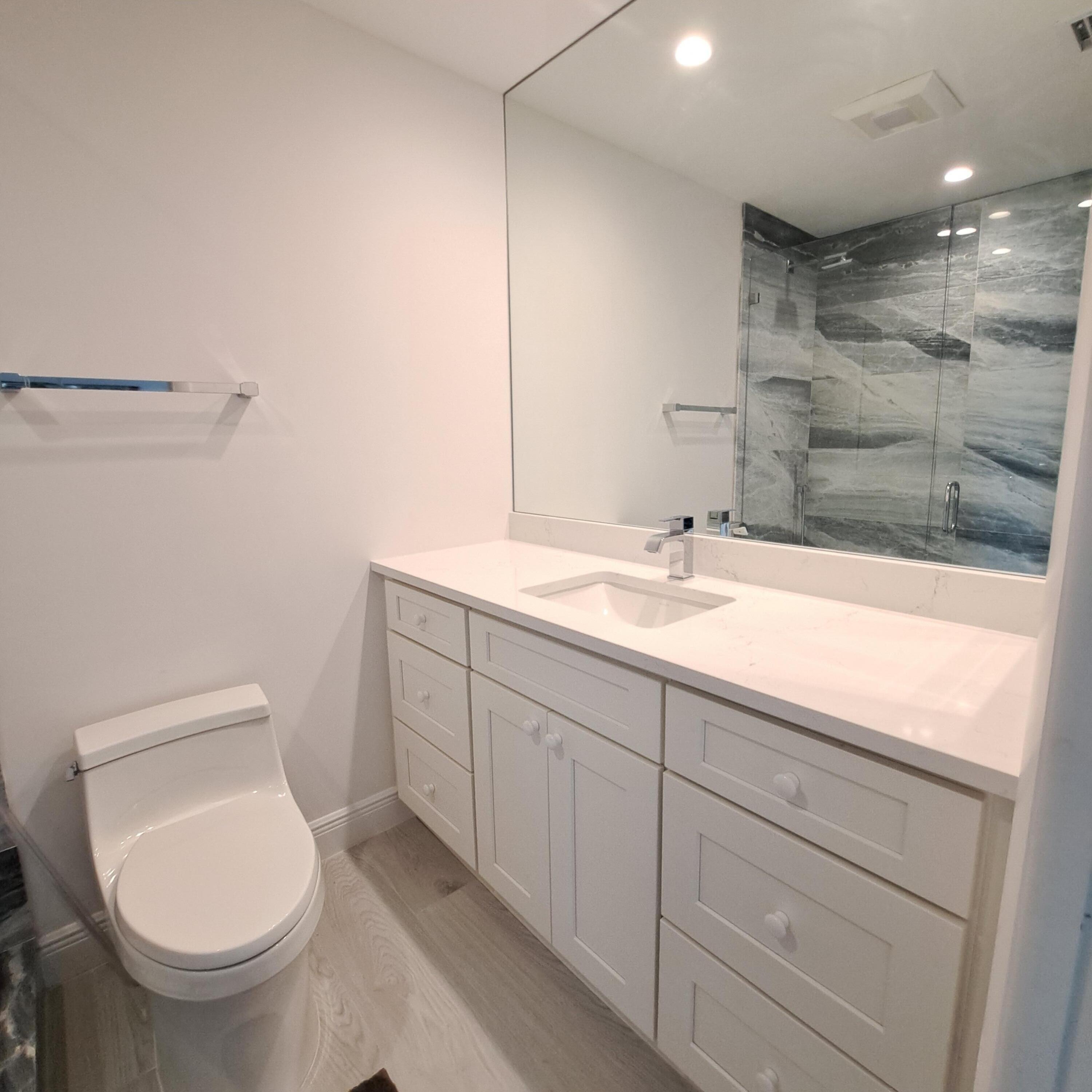 904 Ocean Dunes Circle Jupiter, FL 33477 - Photo 24 of 49 a bathroom with a sink toilet and shower