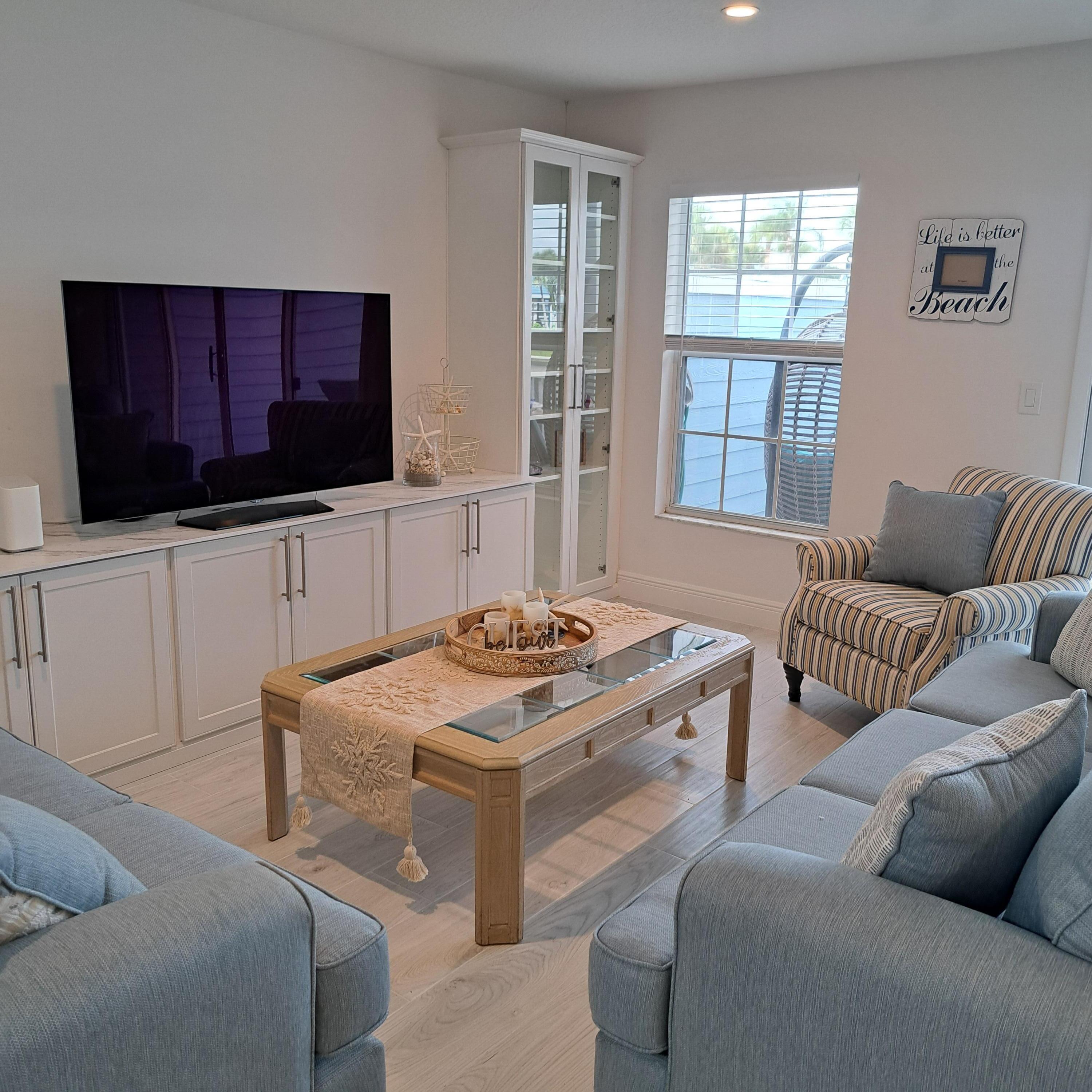 904 Ocean Dunes Circle Jupiter, FL 33477 - Photo 8 of 49 a living room with furniture and a flat screen tv