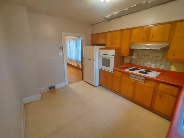 a kitchen with stainless steel appliances a refrigerator and stove