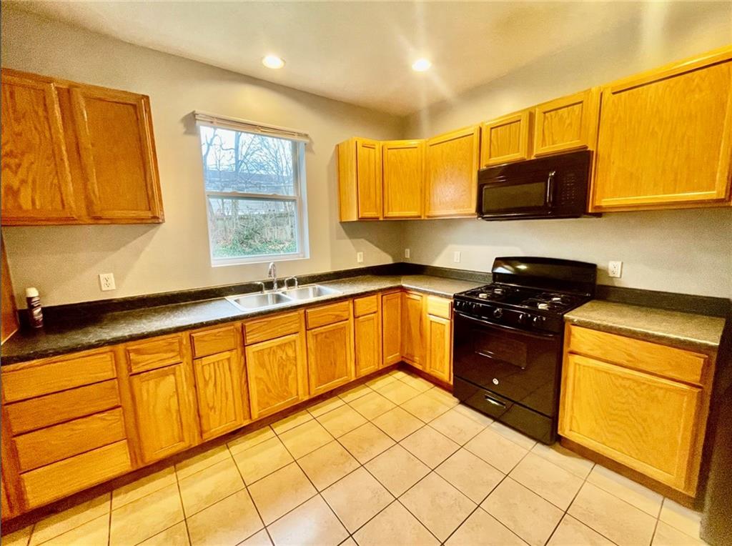 1726 Ridge Avenue Coraopolis, PA 15108 - Photo 16 of 41 a kitchen with granite countertop cabinets and black stainless steel appliances