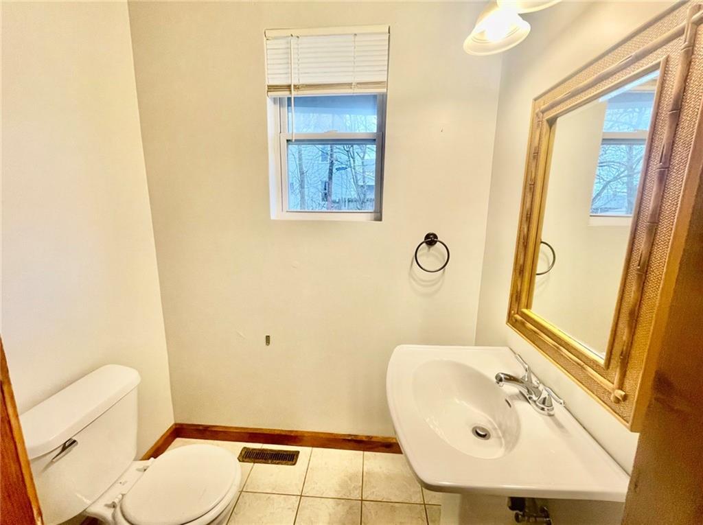1726 Ridge Avenue Coraopolis, PA 15108 - Photo 19 of 41 a bathroom with a sink a toilet and a mirror