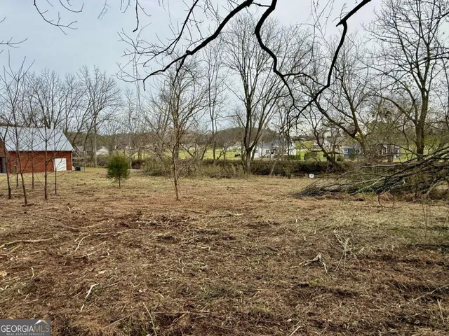 a backyard of a house with large trees