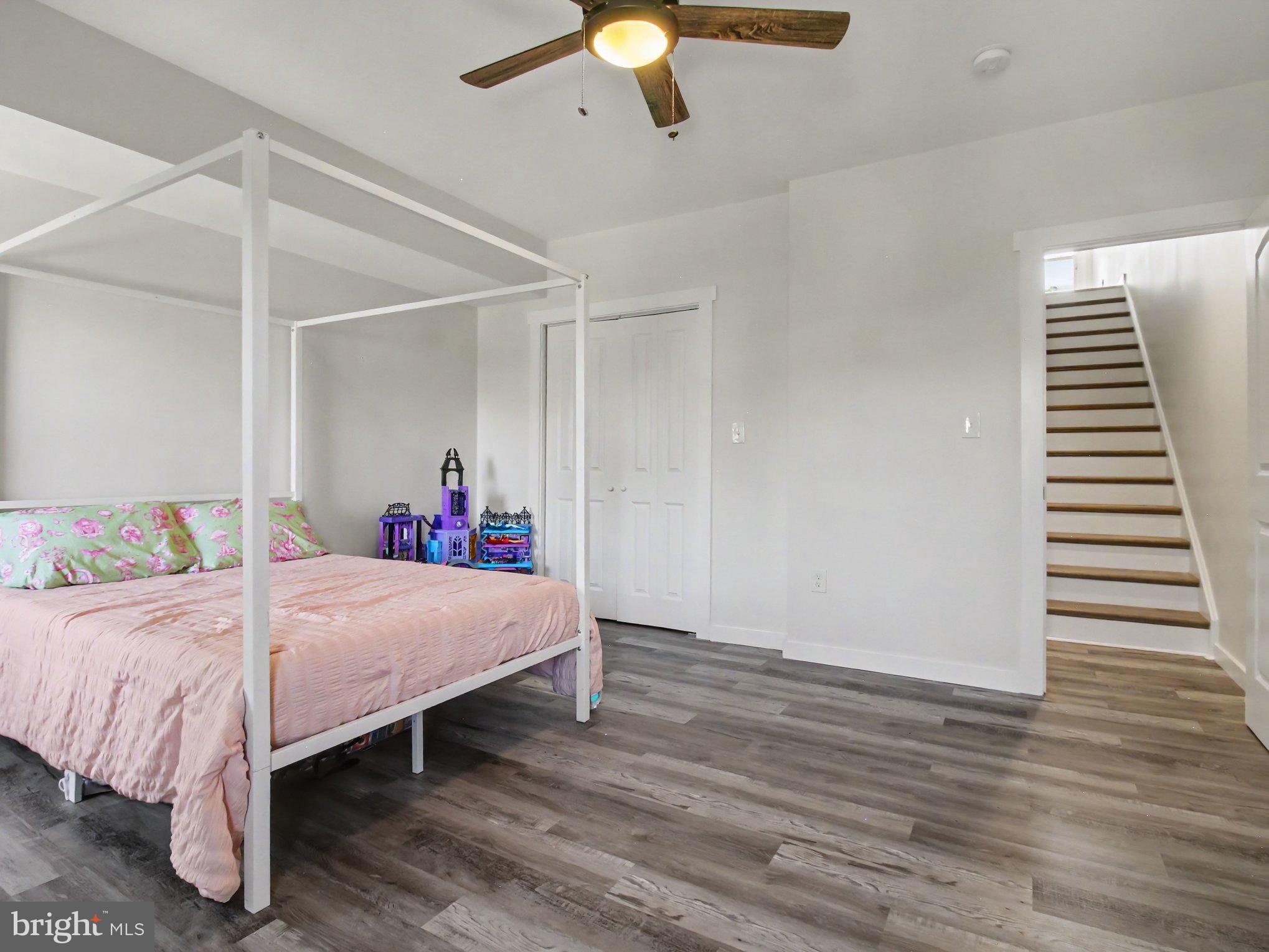3915 Roland Avenue Baltimore, MD 21211 - Photo 9 of 26 a bedroom with a bed and wooden floor