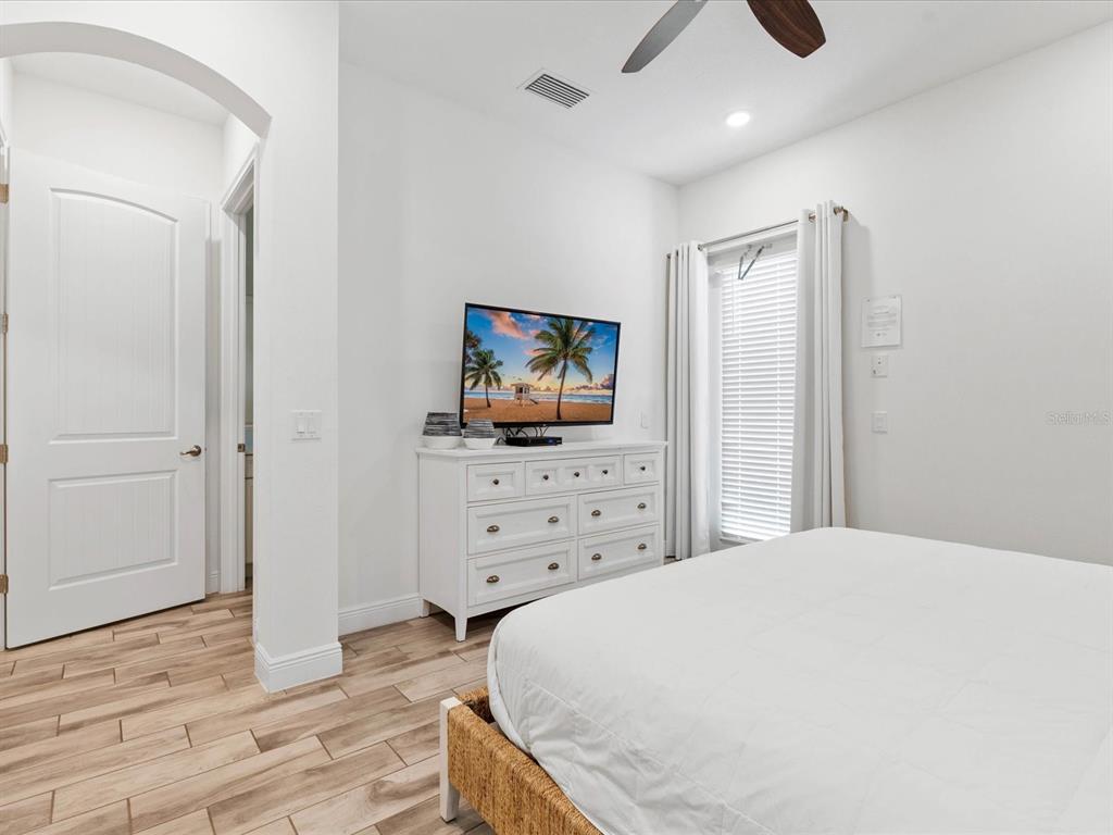 8092 Knee Deep Road Kissimmee, FL 34747 - Photo 13 of 26 a bedroom with a bed and a flat screen tv