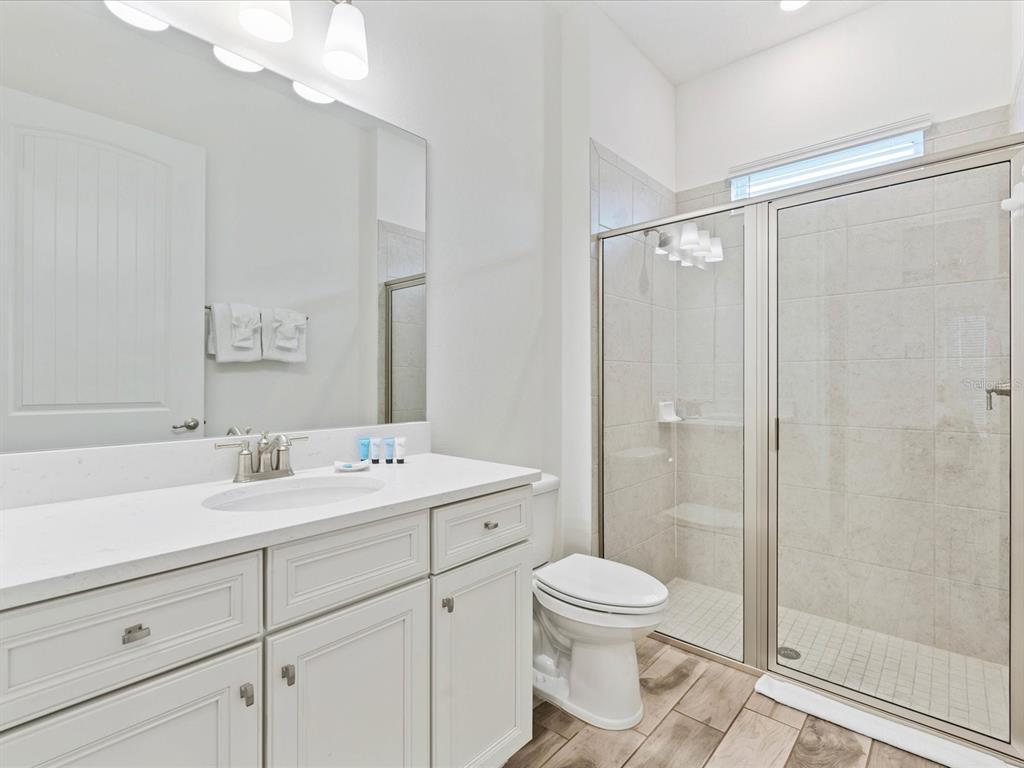 8092 Knee Deep Road Kissimmee, FL 34747 - Photo 14 of 26 a bathroom with a sink mirror toilet and shower