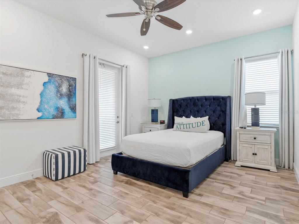 8092 Knee Deep Road Kissimmee, FL 34747 - Photo 15 of 26 a bedroom with a large bed and a chandelier