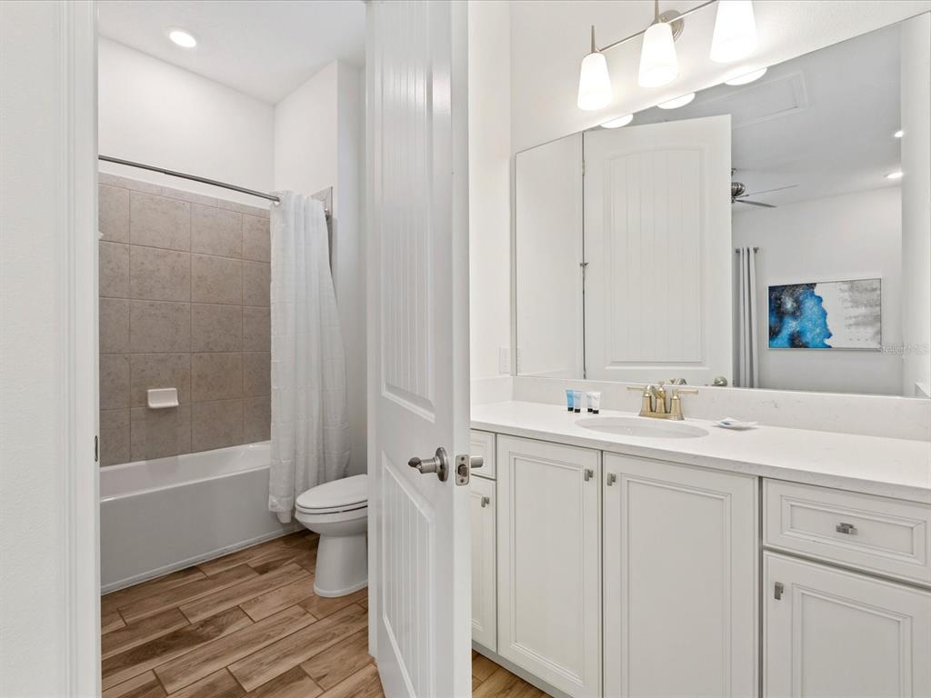 8092 Knee Deep Road Kissimmee, FL 34747 - Photo 18 of 26 a bathroom with a double vanity sink mirror and toilet