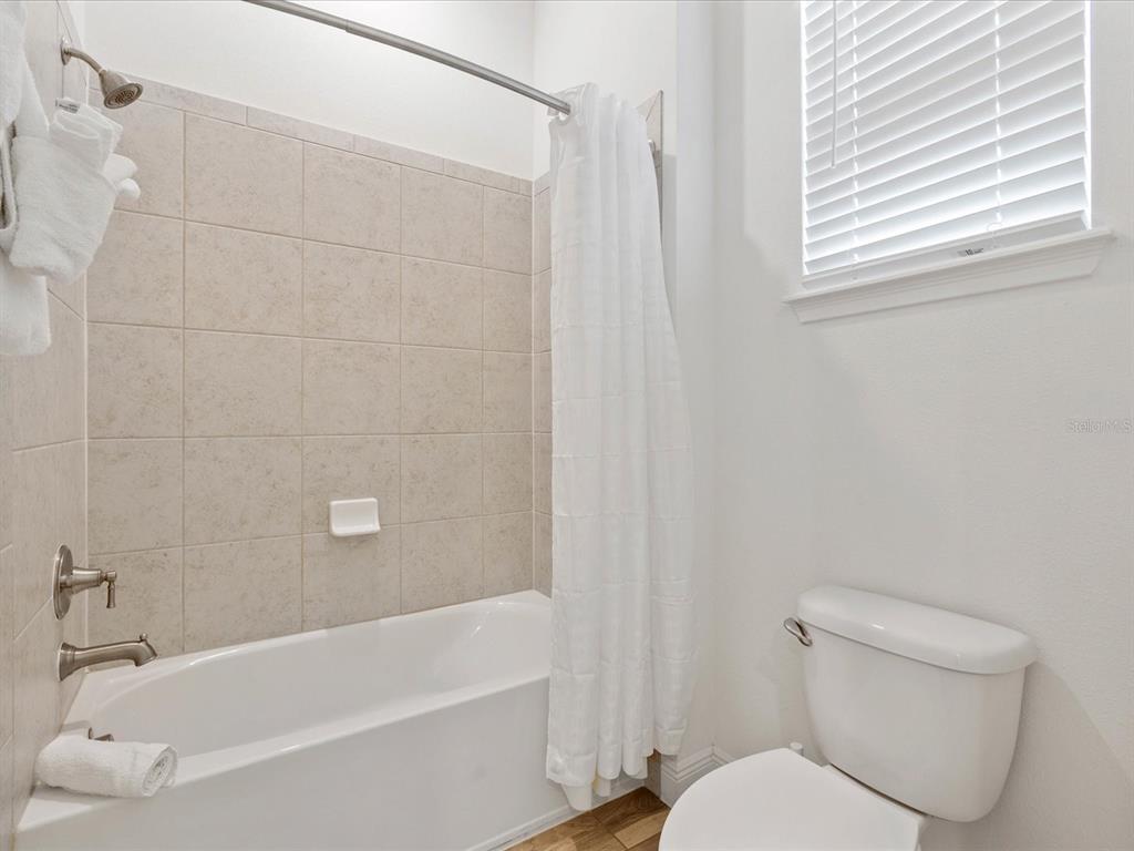 8092 Knee Deep Road Kissimmee, FL 34747 - Photo 19 of 26 a white toilet sitting next to a bath tub