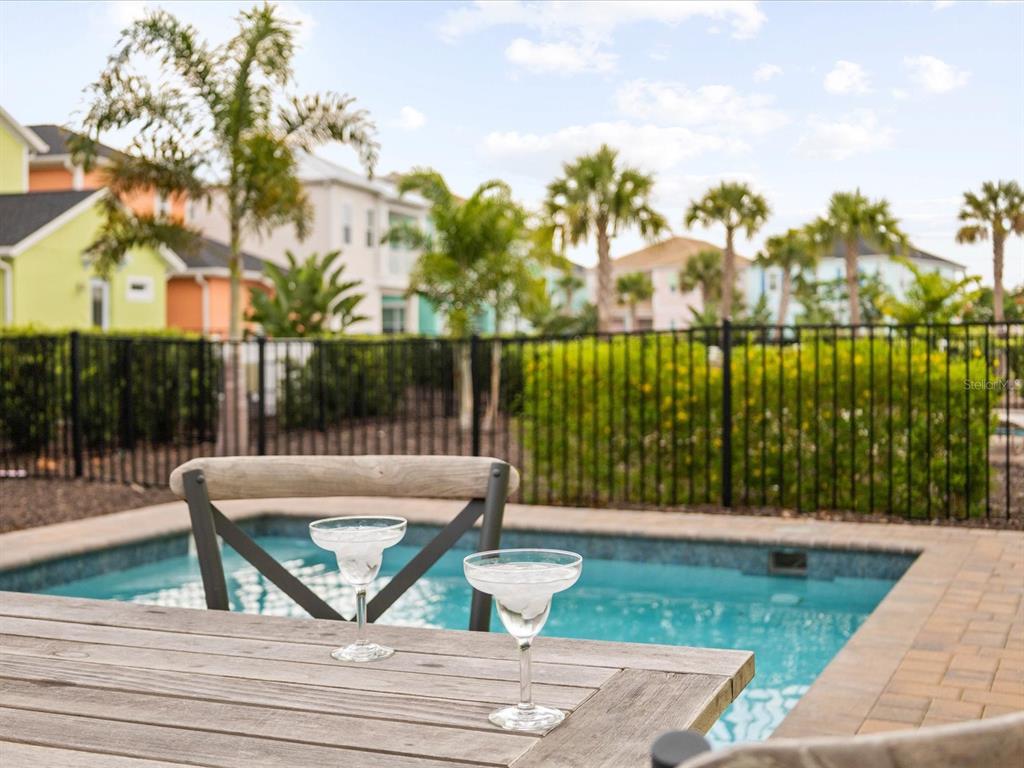 8092 Knee Deep Road Kissimmee, FL 34747 - Photo 21 of 26 a view of a patio with couches table chairs and wooden floor
