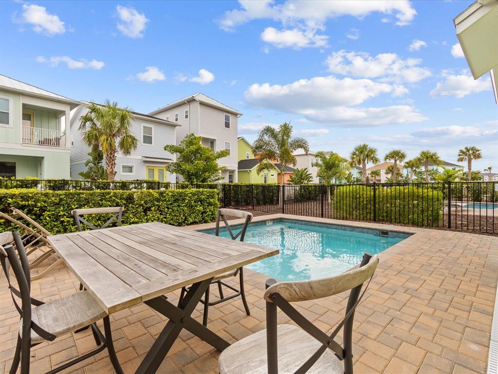 8092 Knee Deep Road Kissimmee, FL 34747 - Photo 3 of 26 a view of a patio with table and chairs and potted plants