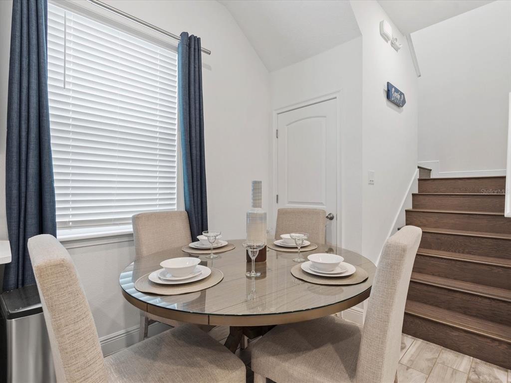 8092 Knee Deep Road Kissimmee, FL 34747 - Photo 9 of 26 a view of a dining room with furniture and wooden floor