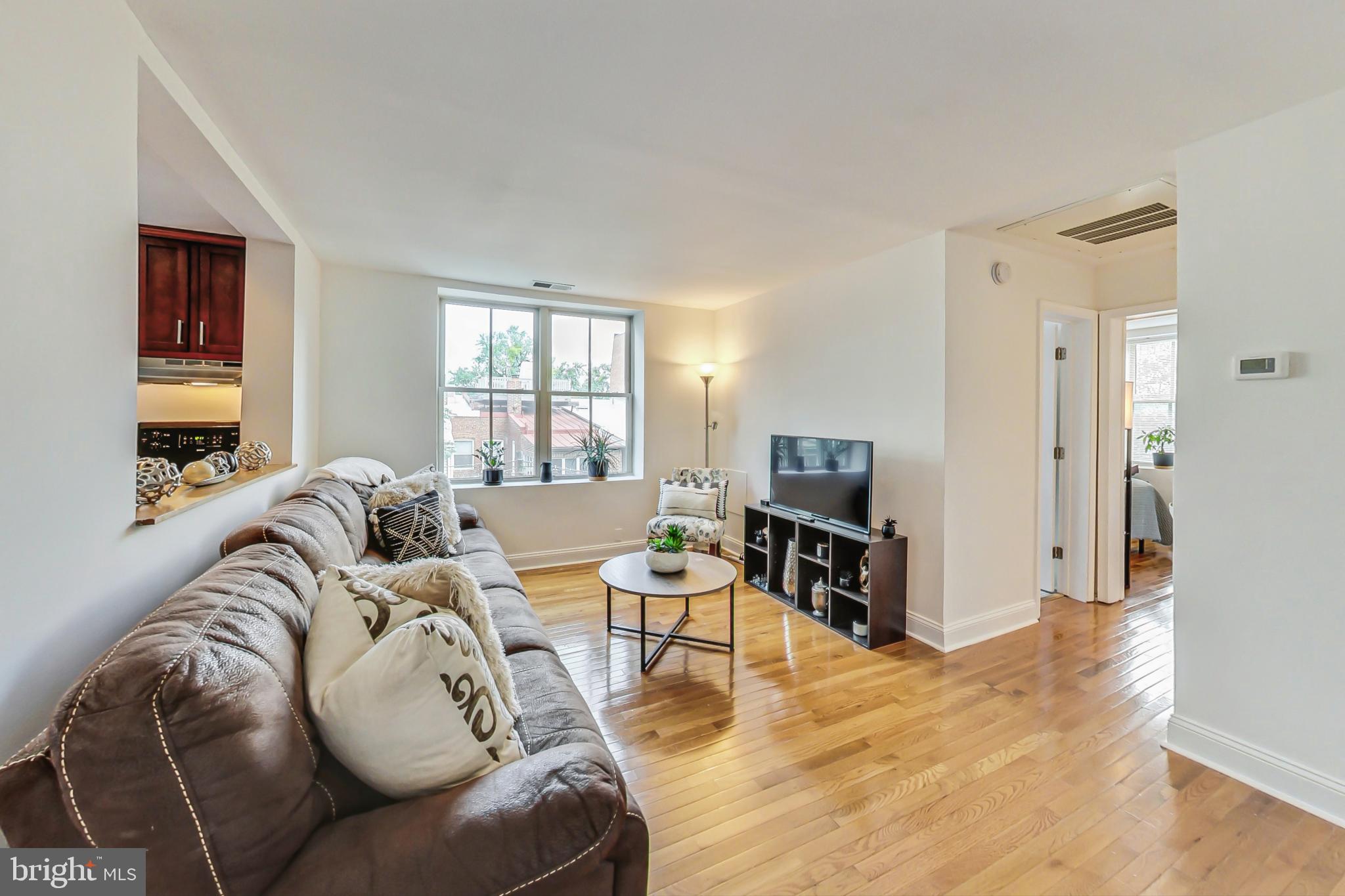 a living room with furniture window and a flat screen tv