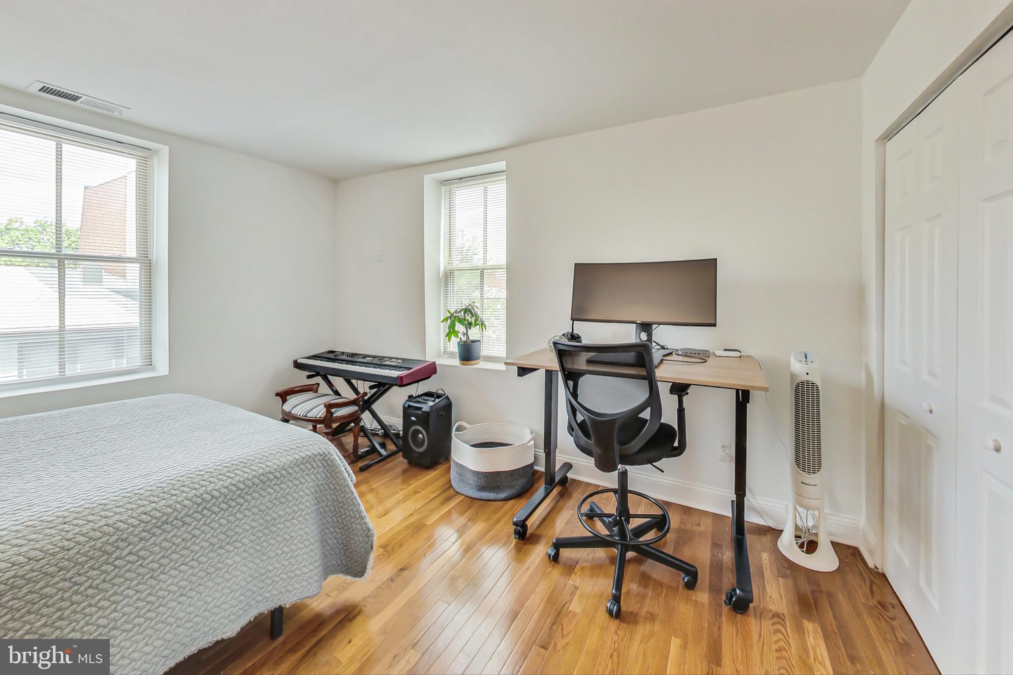 1451 Park Road Northwest, Unit 303 Washington, DC 20010 - Photo 14 of 27 a bed room with a bed and a chair