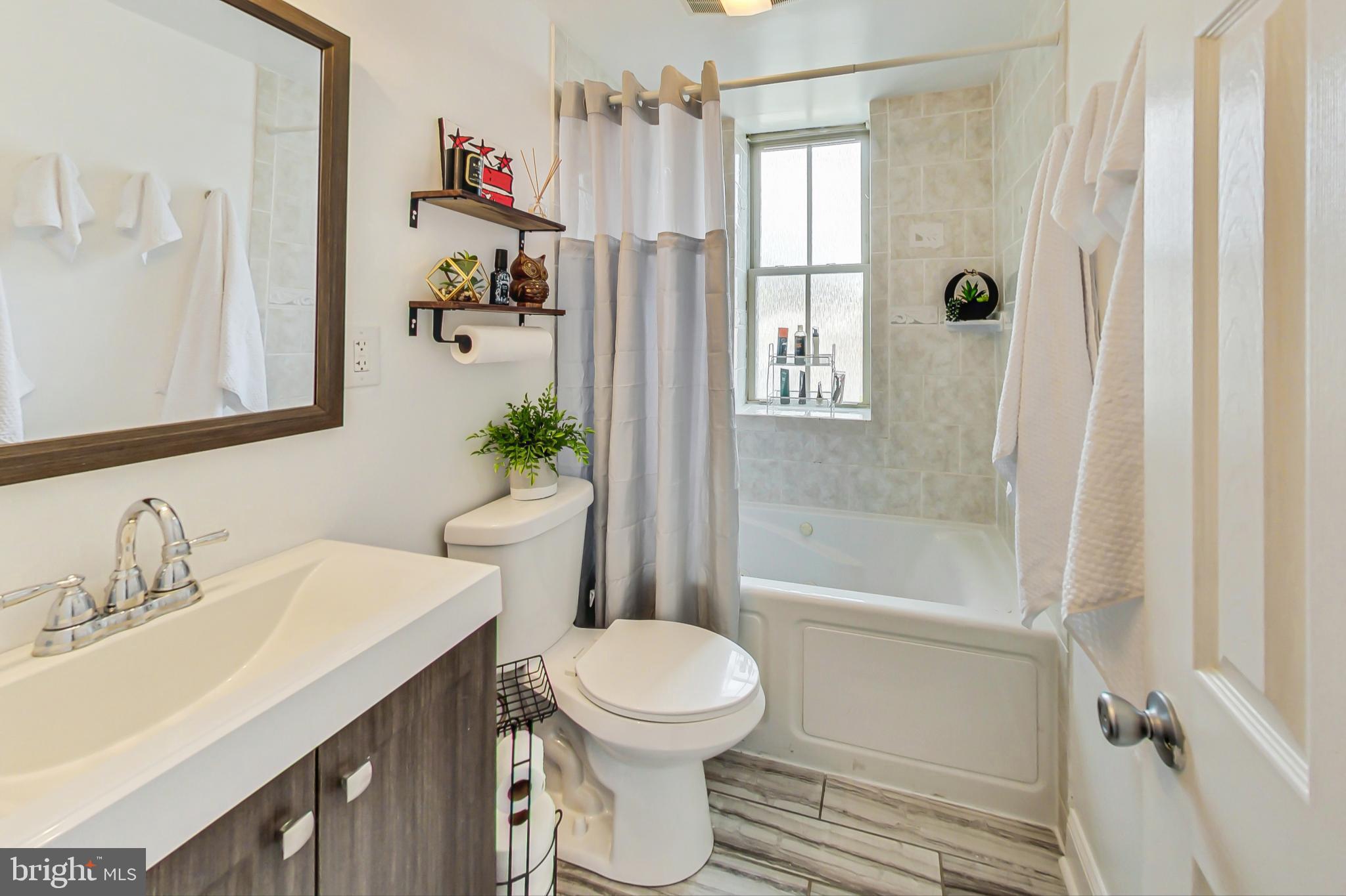 1451 Park Road Northwest, Unit 303 Washington, DC 20010 - Photo 16 of 27 a bathroom with a sink a toilet and shower